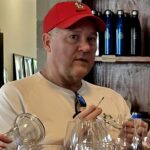 Indulge Boise Tour Guest enjoying a wine tasting at Proletariat Wine Company during The Boise River Urban Wine Trail Tour